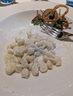 The national dish of Slovakia. Potato dumplings with sheep cheese. I was half finished before I remembered to take a picture.